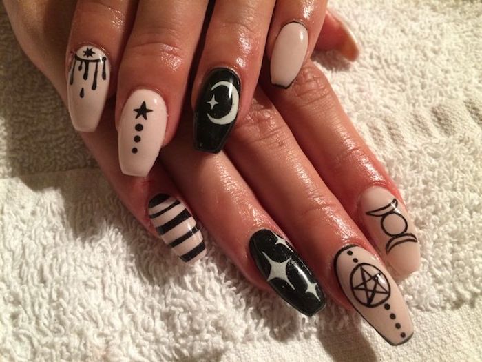 stars and stripes, moons and other shapes, on the nude pink, and black manicure of two hands, with squoval nails 