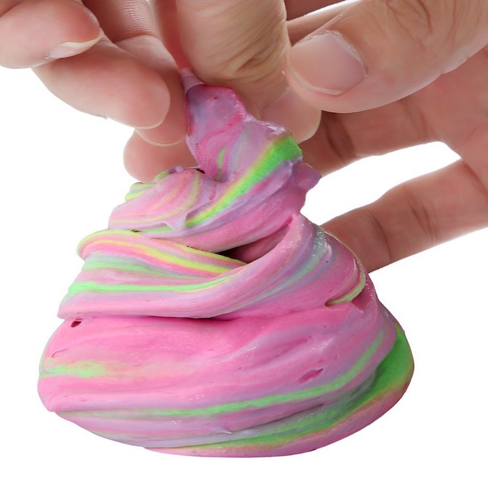 playing with a pile of multicolored goo, two hands twisting its top part, how to make slime with borax, pink with green, yellow and blue streaks