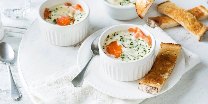 salmon pieces with creamy white sauce and dill, inside small ceramic dishes, served with spoons, and small strips of bread, what is a healthy breakfast
