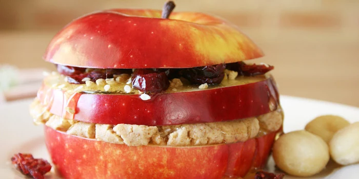 simple breakfast ideas, sliced red apple, with stuffing between the slices, honey seeds and raisins, mushy beige oatmeal