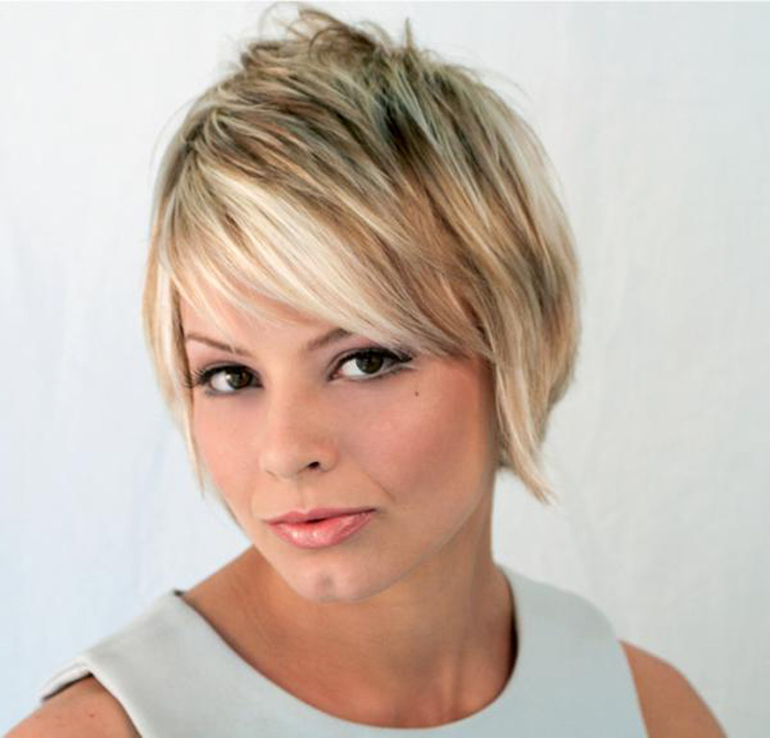 pale duck's egg sleeveless top, worn by woman with dark eyes, with a retro inspired, layered and textured pixie cut, dark blonde with platinum highlights