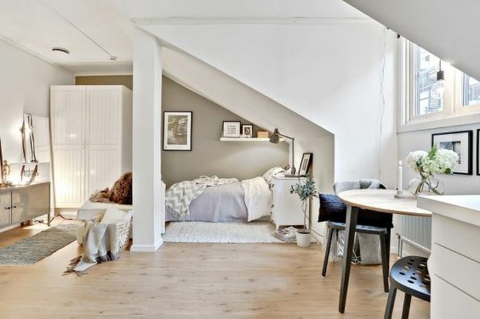 home decor inspiration, white wardrobe and a bed in light colors, pale beige laminate floor, small table with two dark chairs