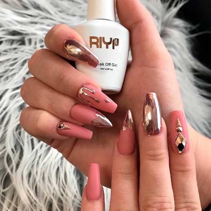 dripping effect detail, and rose gold metallic decorations, on two hands, with oval nails, most have square tips, but two nails have sharp tips