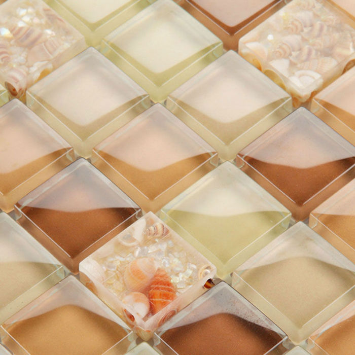 glass mosaic tile backsplash, in glossy brown, orange and light yellow, containing small conch seashells, in similar colors