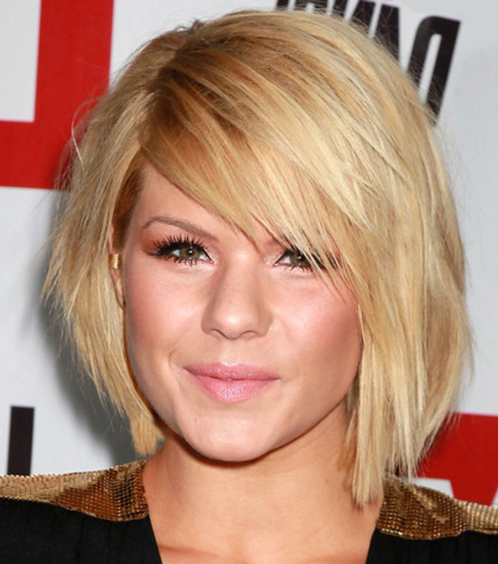 layered blond bob, with added volume, worn by smiling young woman, with faux eyelashes and mascara, wearing a black and gold sequin top