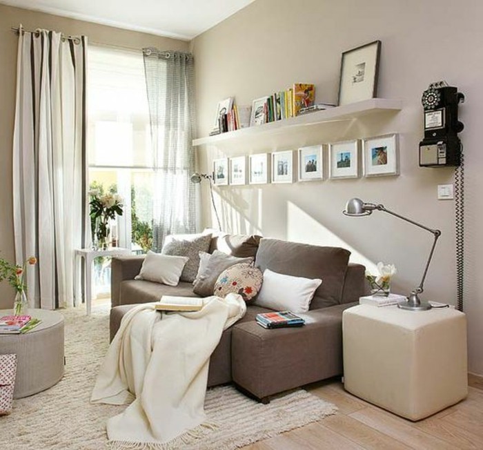 seven images in silver frames, on a pale beige wall, inside a bright living room, with laminate floor, and light beige rug, couches for small living rooms