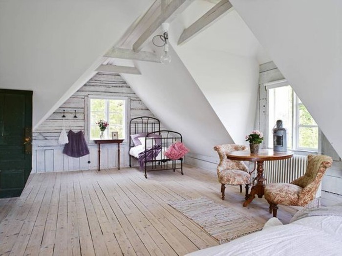 vintage-inspired furniture, inside a spacious attic room, room design, black wrought iron bed, two retro armchairs, ornate wooden coffee table