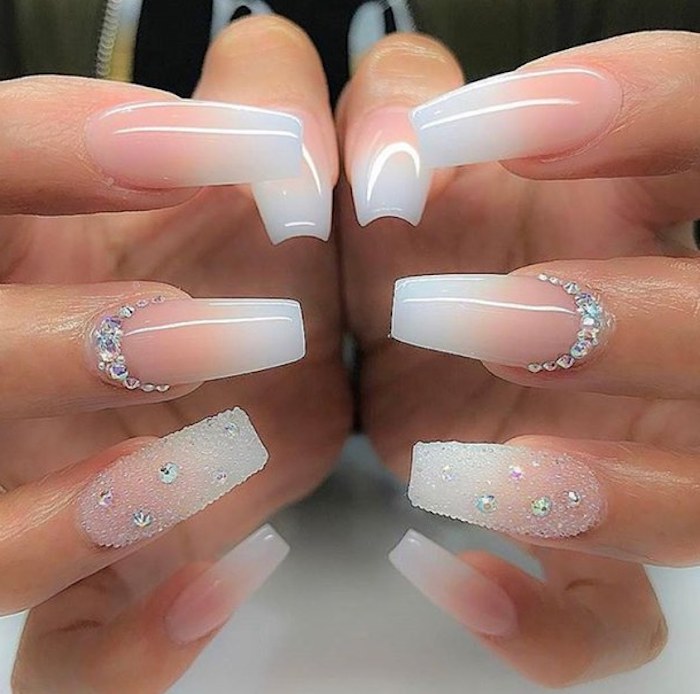 bridal manicure idea, long coffin-style nails, with pink and white ombre-like nail polish, decorated with rhinestones and glitter