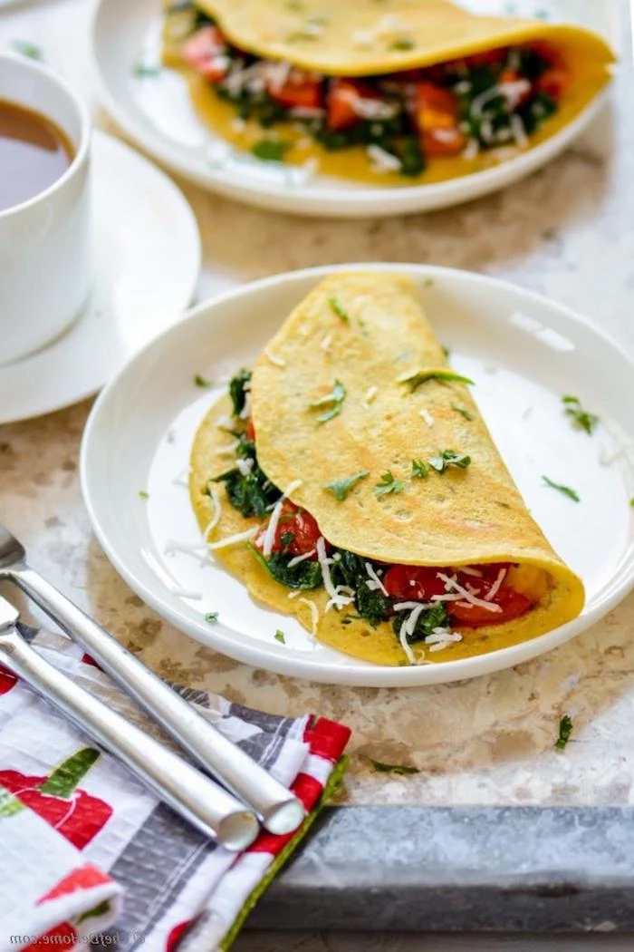 omelettes stuffed with fresh vegetables, cherry tomato and spinach, and dusted with parsley and grated cheese, what is a healthy breakfast, cup of tea nearby 