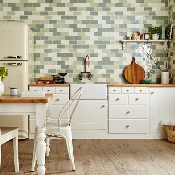 green in different shades, on a subway tile kitchen backsplash, inside a kitchen with a vintage fridge, and white cabinets