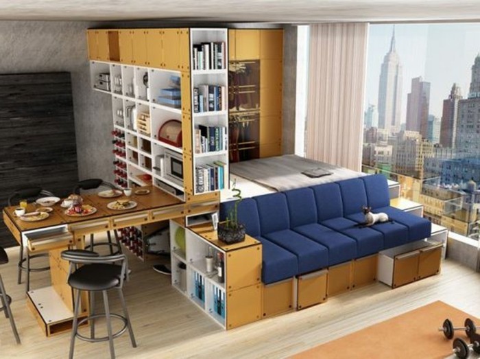 foldable furniture inside a studio flat, navy blue sofa, with storage compartments, dining table with four black chairs, couches for small living rooms, large window with a city view