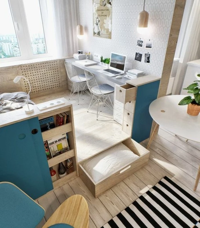 storage spaces and drawers, inside a bright room, with light beige wooden floor, living room furniture for small spaces, furniture with teal accents, grey desk with two chairs