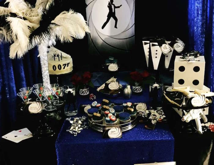 martini glasses and little tuxedo party favors, ostrich feather decoration, a large playing dice, and cupcakes with gambling chips, 60th birthday party ideas, inspired by agent 007