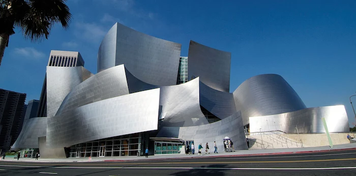 silver-colored building, comprised by several abstract shapes, resembling welded metal, postmodernism characteristics, the walt disney concert hall in los angeles 