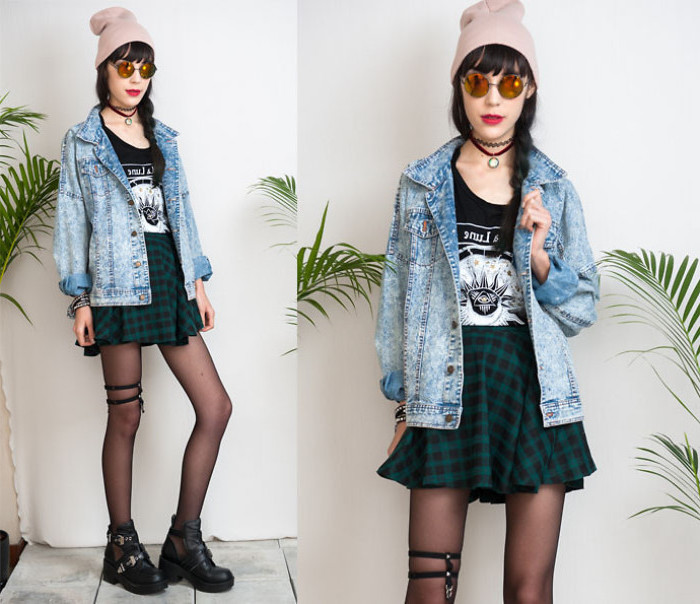 grunge goth style outfit, green and black checkered mini skirt, black t-shirt with print, acid wash denim jacket, round sunglasses and a beanie, 90s halloween costumes