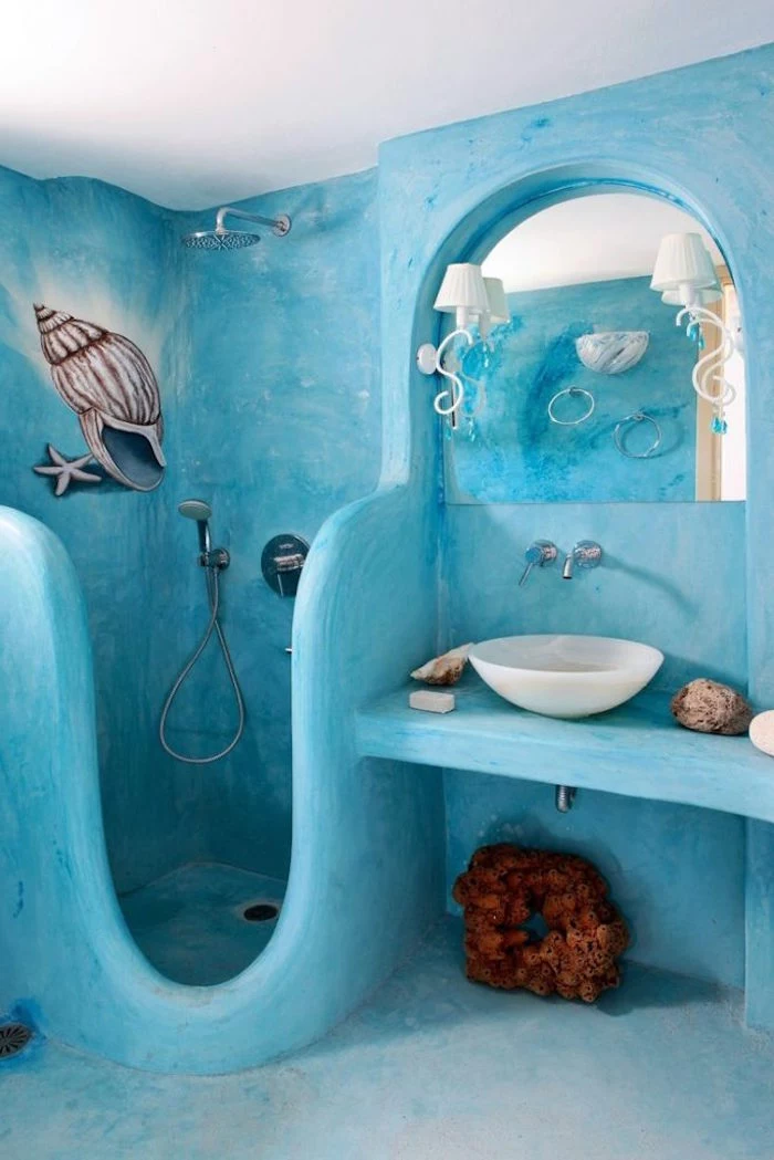conch shell and starfish, hand painted on the turquoise walls of an unusual, diy bathroom, brown decorative coral and a mirror