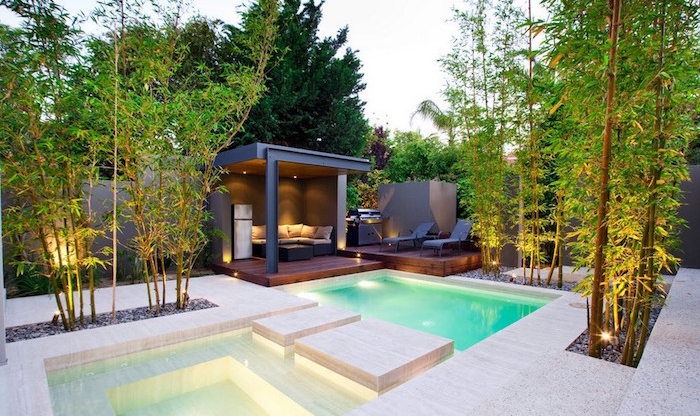 metal gazebo with a sofa, near a modern off-white pool, surrounded by bamboo plants, small backyard pool ideas 