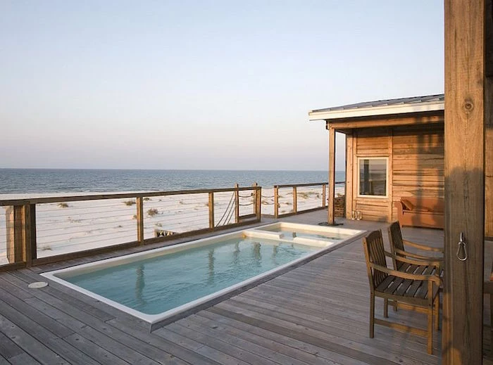 seaside bungalow made of wood, with a rectangular patio pool, white sand and sea nearby