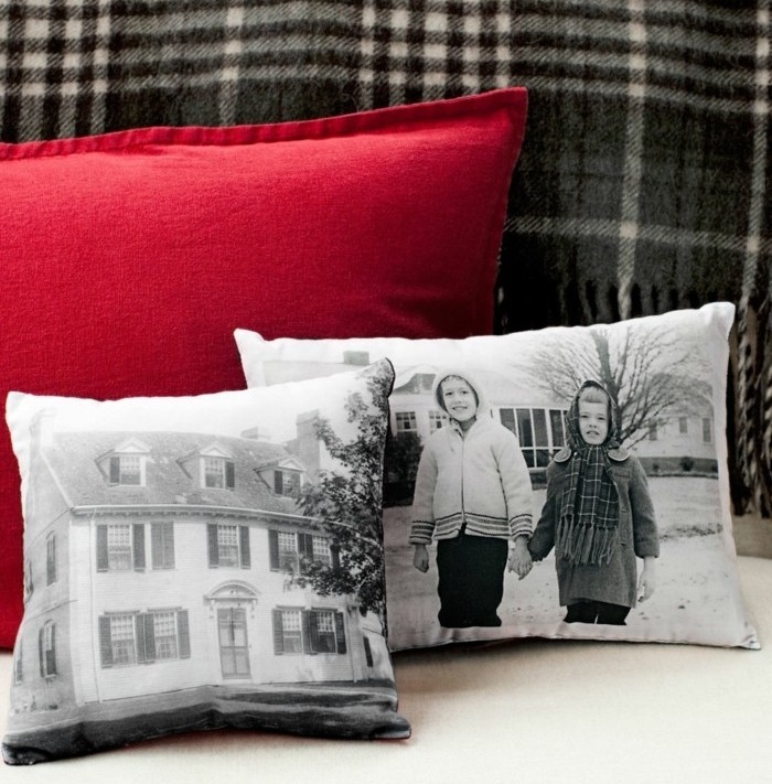 customized white cushions, with greyscale images, of a large house, and two children holding hands, last minute birthday gifts, large red cushion behind them