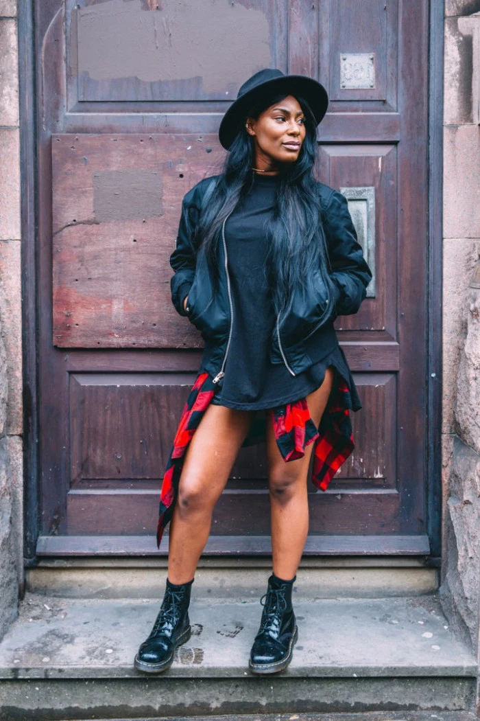 90s outfit ideas, black leather jacket, worn by a black woman, with long black hair, a black t-shirt, and a red flannel shirt, tied around waist