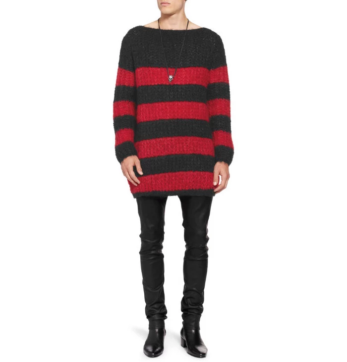 striped red and black, long and baggy knitted sweater, worn by a slim man, in black leather trousers, 90s themed outfits, black ankle boots and skull necklace