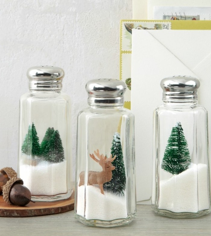 salt and pepper shakers, filled with faux snow, and decorated with tiny christmas trees, and a reindeer figurine, handmade gifts
