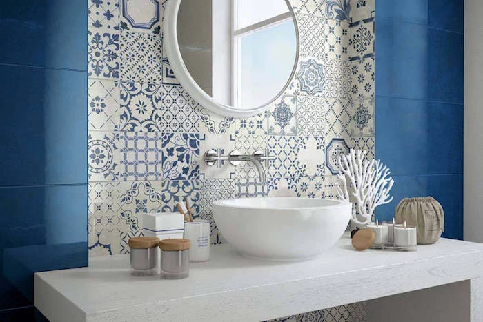 candles and a white, coral-shaped decoration, on a white counter with a sink, diy bathroom décor, near a wall covered in blue, and white moroccan tiles