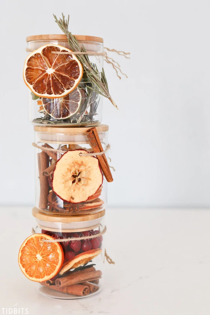 three different types of potpourri in glass jars, stacked one on top of the other, diy christmas gifts, white background