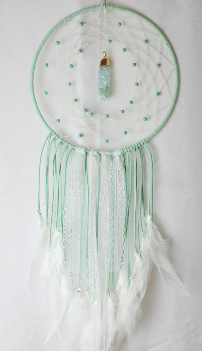 light turquoise dreamcatcher, decorated with white feathers, turquoise beads, and a light blue crystal, large dream catcher