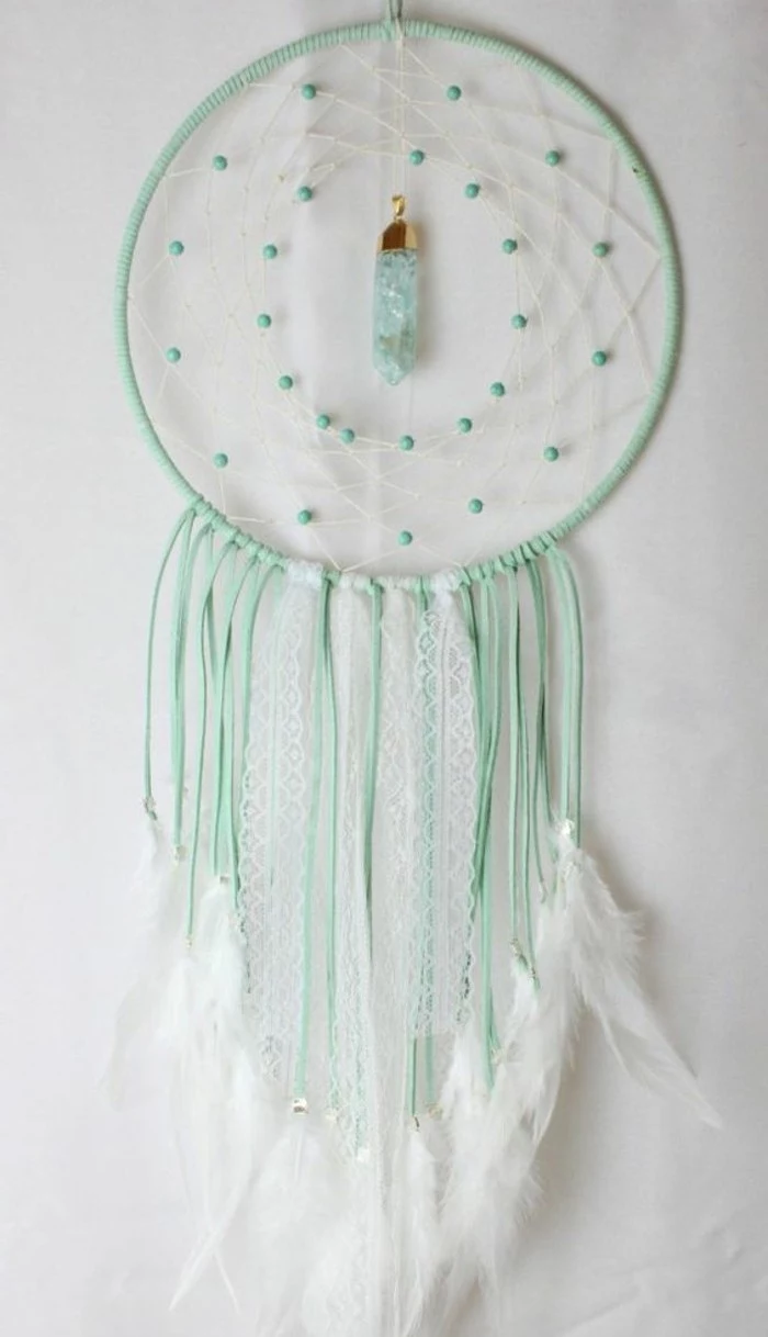 light turquoise dreamcatcher, decorated with white feathers, turquoise beads, and a light blue crystal, large dream catcher