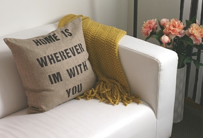 burlap-like cushion in beige, decorated with a romantic message, written in dark grey, homemade gift ideas, on a white leather sofa