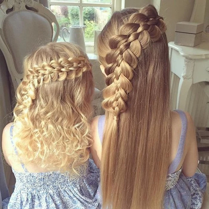 teenage girl with smooth, long blonde hair, and a small child with curly blonde locks, wearing similar side-braided hairdos, seen from the back 