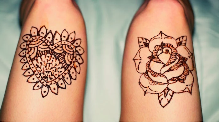 a rose and a heart, decorated with flourishes, cute henna designs, drawn above the knees of two legs