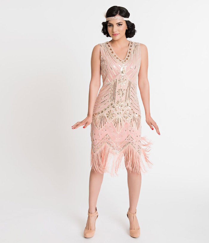 nude pink gatsby dress, featuring shiny silver embroidery, with art deco motifs, on a dark-haired young woman, wearing matching nude pink t-bar shoes