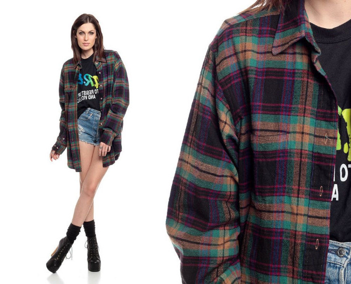 cut off denim shorts, with distressed detail, 90s aesthetic, worn with a black oversized t-shirt, partially tucked in, under a retro flannel shirt