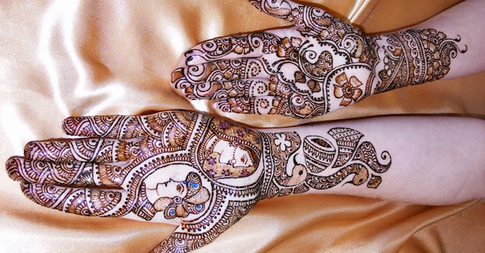 groom and bride, drawn on the hand of a woman, with brown henna, and decorated with splashes of paint