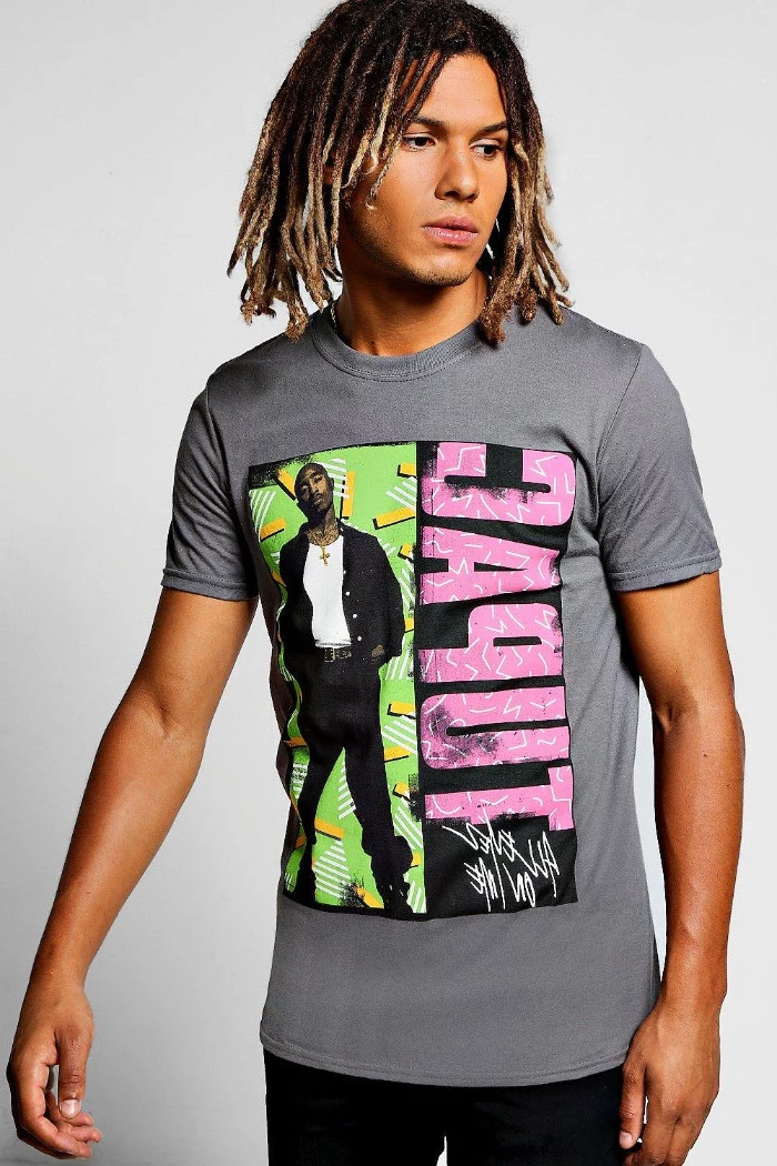90s clothes mens, grey tupac t-shirt, with pink and black, green and yellow print, on a young man, with shoulder length, ombre effect dreadlocks