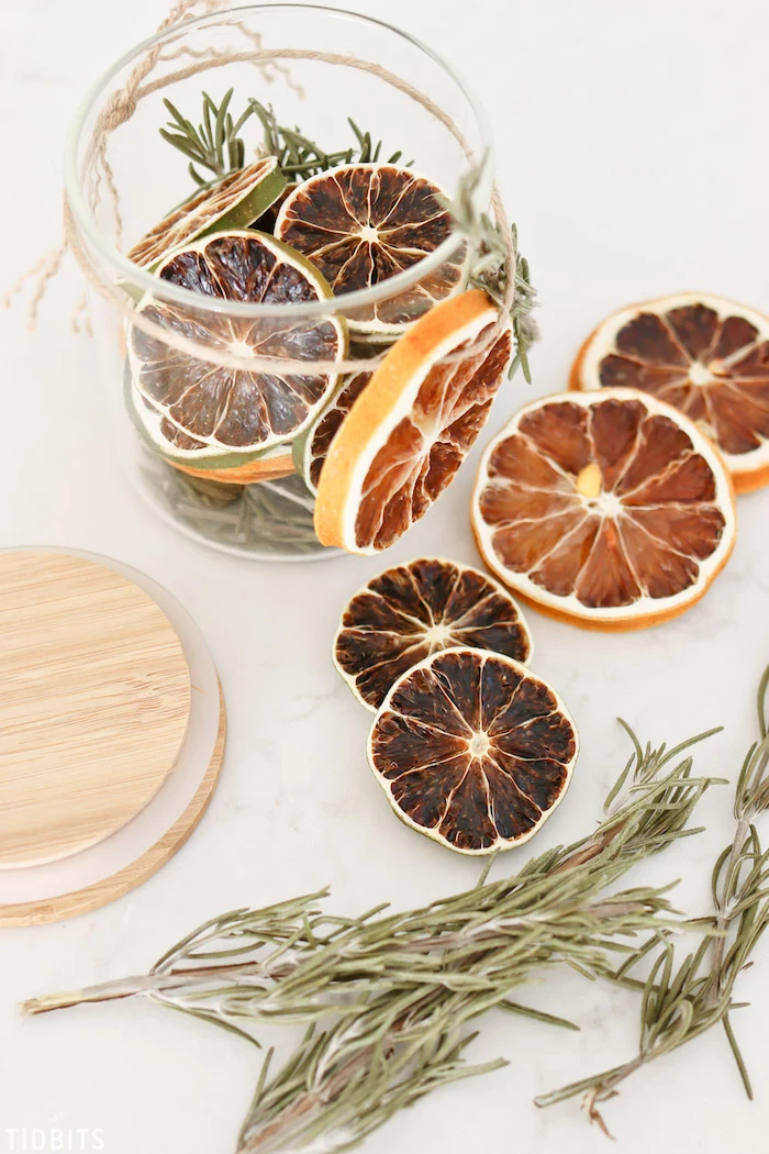 potpourri made in a glass jar, diy christmas gifts, dried lime and lemon slices, rosemary branches inside the jar