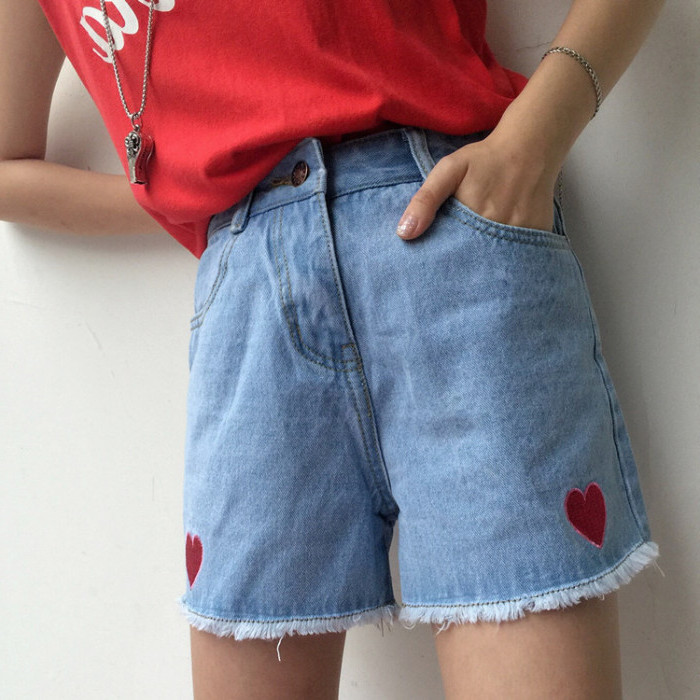 high waisted denim shorts, with frayed hems, and two embroidered red hearts, 90s themed outfits, worn with a red shirt, tucked into them