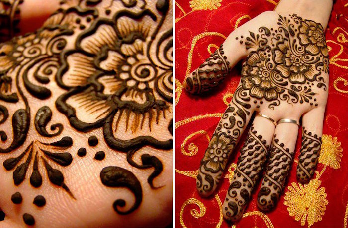palm decorated with freshly made, dark brown henna patterns, seen in extreme close up, and in a medium shot