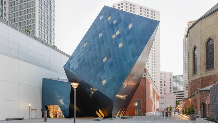 tilted cube-like structure, made of dark reflective glass, postmodern architecture, contemporary jewish museum, san francisco usa