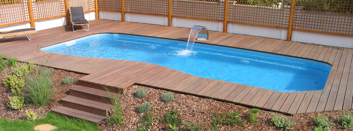 metal faucet pouring water, into a small rectangular pool, surrounded by wooden planks, pool patio ideas, with stairs