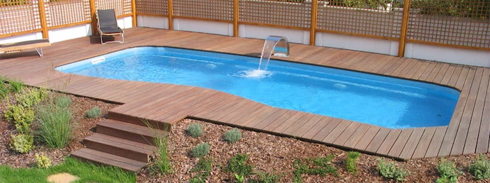 metal faucet pouring water, into a small rectangular pool, surrounded by wooden planks, pool patio ideas, with stairs
