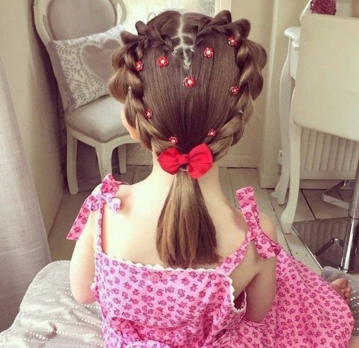 heart shape, made from two linked, symmetrical brunette braids, on a child's head, kids hairstyles, ponytail with red bow, and small floral decorations
