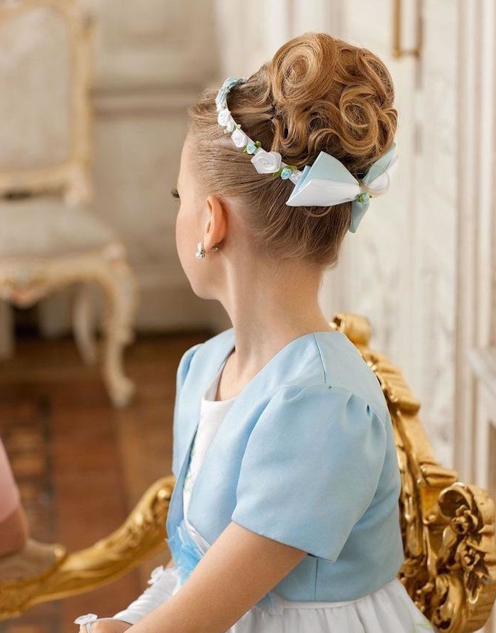 duck's egg blue short blazer, worn over a white dress, by a girl with curly up-do, decorated with a pale blue and white bow