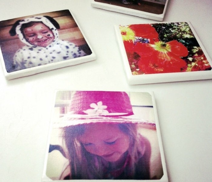 coasters made from thick white material, decorated with colorful family photos, handmade gifts, on a white surface