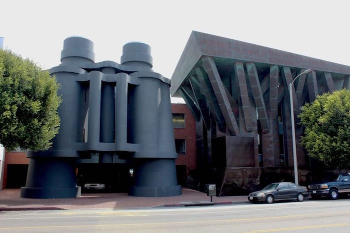 building shaped like a pair of giant binoculars, in dark grey, postmodern architecture in Los Angeles 