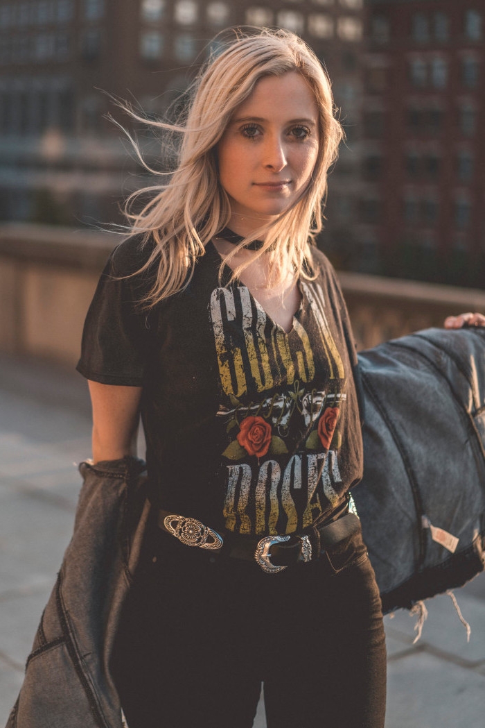 belt in black, with vintage metal details, worn with black jeans, and a black guns'n'roses t-shirt, by a blonde young woman, with a black choker necklace