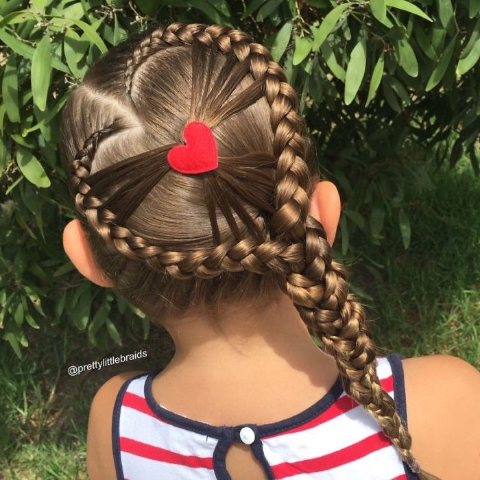 decoration shaped like a heart, on a small brunette girl's head, surrounded by two braids, forming a large heart-shape