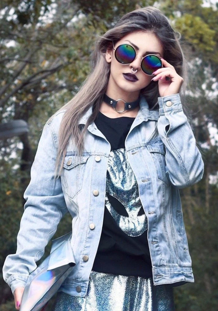 round sunglasses and a nose ring, on a young woman, with a black t-shirt, featuring a holographic alien print, 90s halloween costumes, holographic skirt and a pale denim jacket